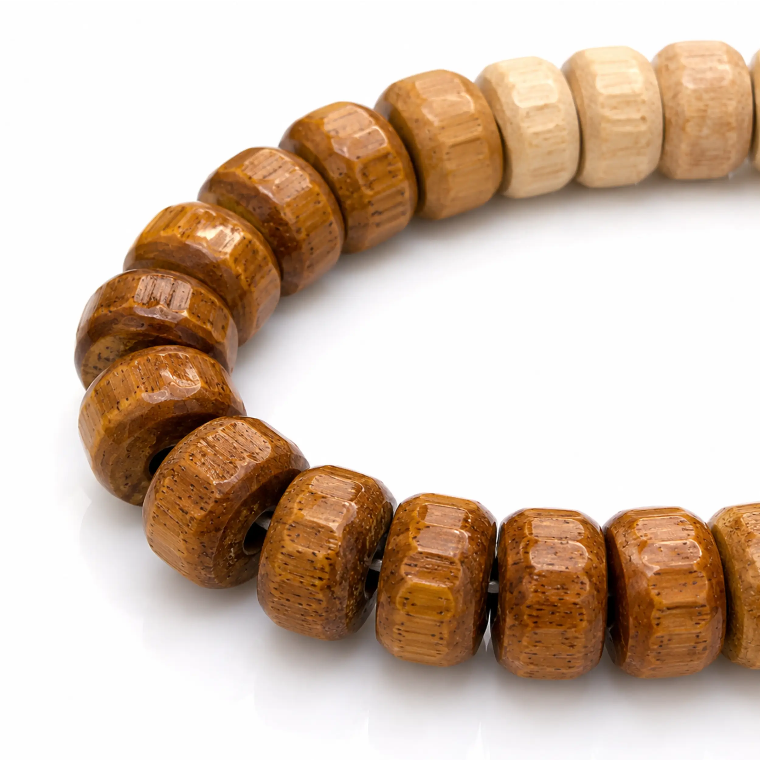 Close-up of natural eucalyptus wood beads showing the two-tone colour and grain texture of the tasbih