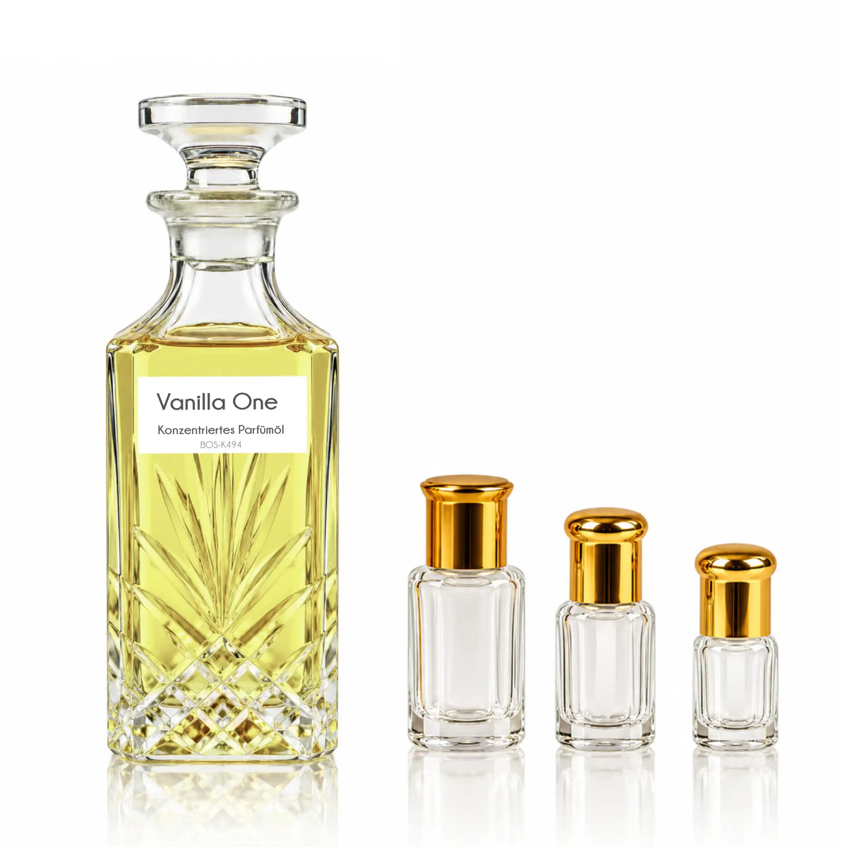 Vanilla One Gourmand-Parfümöl von Sultan Essancy im verzierten Glasflakon mit goldgelbem Öl, daneben drei kleine Flakons mit goldfarbenen Verschlüssen.
