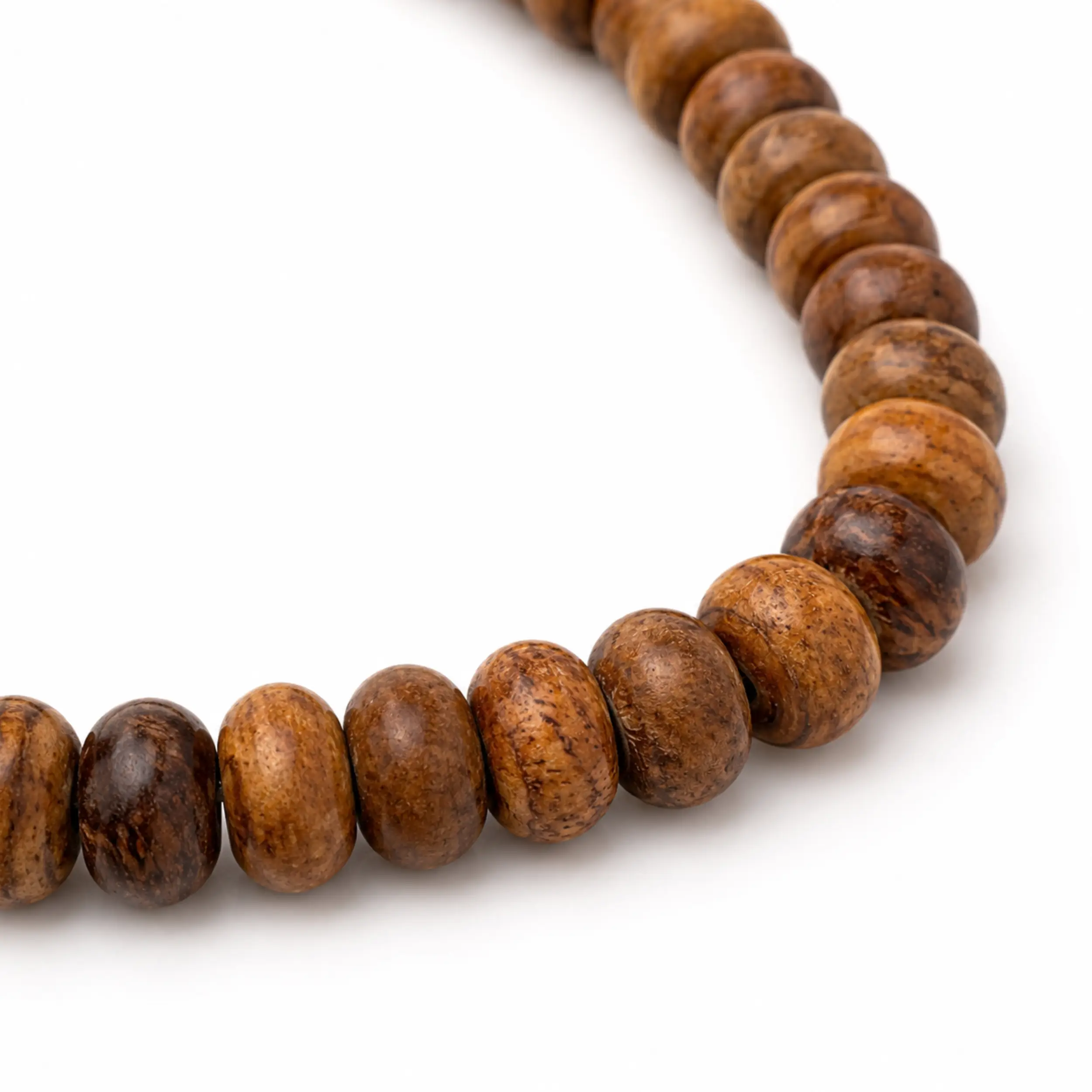 Nahaufnahme der braun gemaserten Perlen einer Tasbih aus Eukalyptusholz